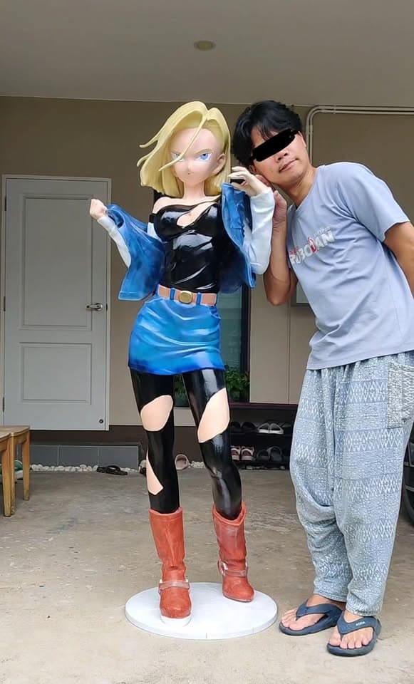 Life-size Android 18 collectible displayed beside a collector